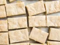 Ted Lasso Shortbread Bars by Wood and Spoon blog. These are English biscuits inspired by the hit TV show Ted Lasso. These shortbread cookie bars are made with butter, brown sugar, and powdered sugar. They require less than 10 ingredients and 5 minutes of prep time, and they are perfect for for Ted Lasso viewing party! Find the how to and recipe on thewoodandspoon.com