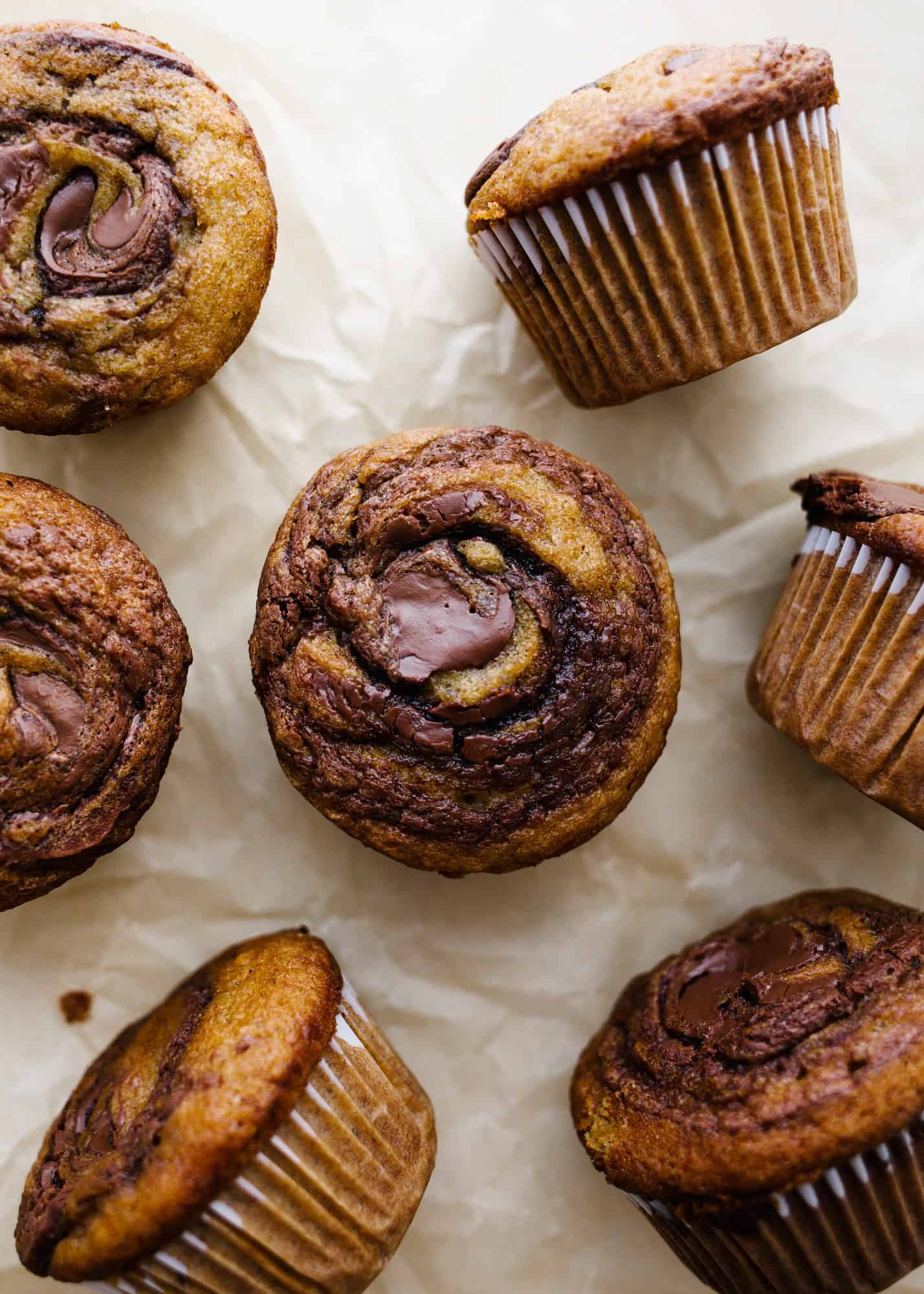 Banana Nutella Muffins by Wood and Spoon Magazine. These are simple banana muffins made with ripe bananas and a gooey swirl of chocolate hazelnut spread. The muffins stay moist for days and benefit from the extra sweet of Nutella swirled into the center of each muffin. Learn how simple it is to make this breakfast brunch treat on thewoodandspoon.com