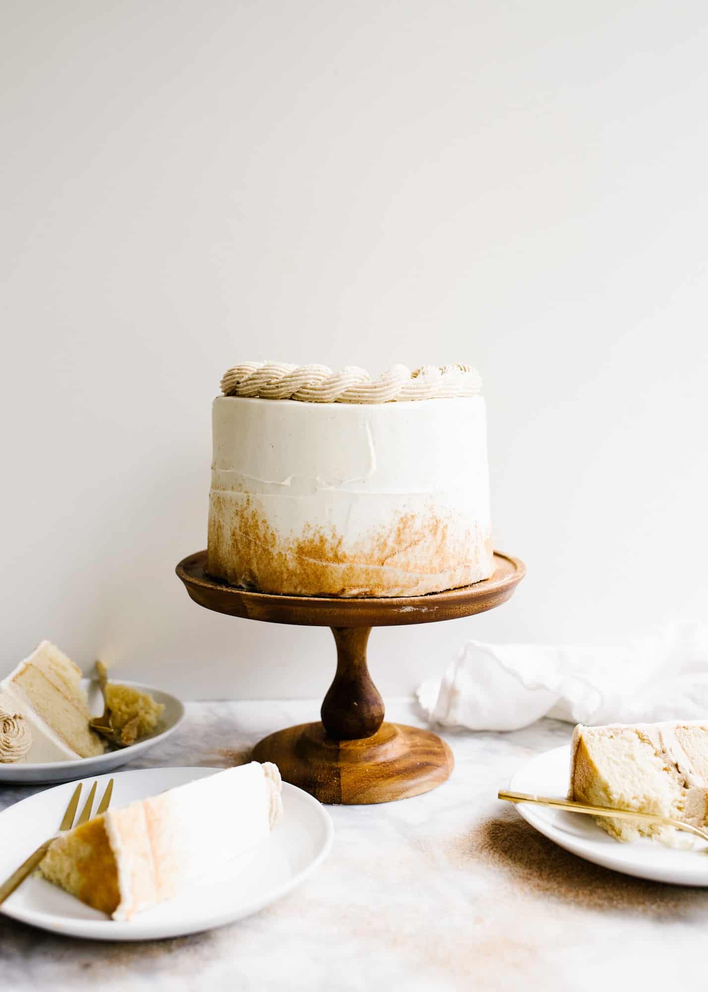 Cinnamon Sugar Cake by Wood and Spoon blog. This is a fluffy brown sugar cake with a salted cinnamon brown sugar filling and vanilla bean frosting. This spiced dessert is perfect for fall birthday parties or holiday gatherings or anyone who loves good cozy flavors. Learn more about this cake on thewoodandspoon.com