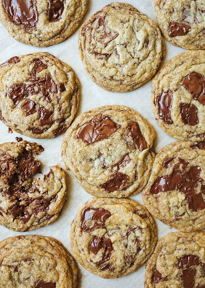 Vegan Chocolate Chip Cookies Recipe By Wood and Spoon Blog by Kate Wood. These are coconut oil and flaxseed meal egg cookies make with jumbo dark chocolate chunks with gooey centers. The cookies are big with crispy edges and chewy centers. The cookies are made with organic sugars and can be made gf with a one for one flour mix. This is a one bowl simple recipe that requires no rest time. Cookies can be made ahead and stored in the freezer. Find the recipe and how to for these dairy free treats on thewoodandspoon.com