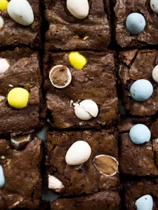 Mini Egg Brownies by Wood and Spoon blog. These are chewy homemade brownies filled with Cadbury mini eggs. These brownies are a great alternative to box mix brownies and the pastel candies make the brownies festive for the spring and Easter holidays. Find the recipe on thewoodandspoon.com