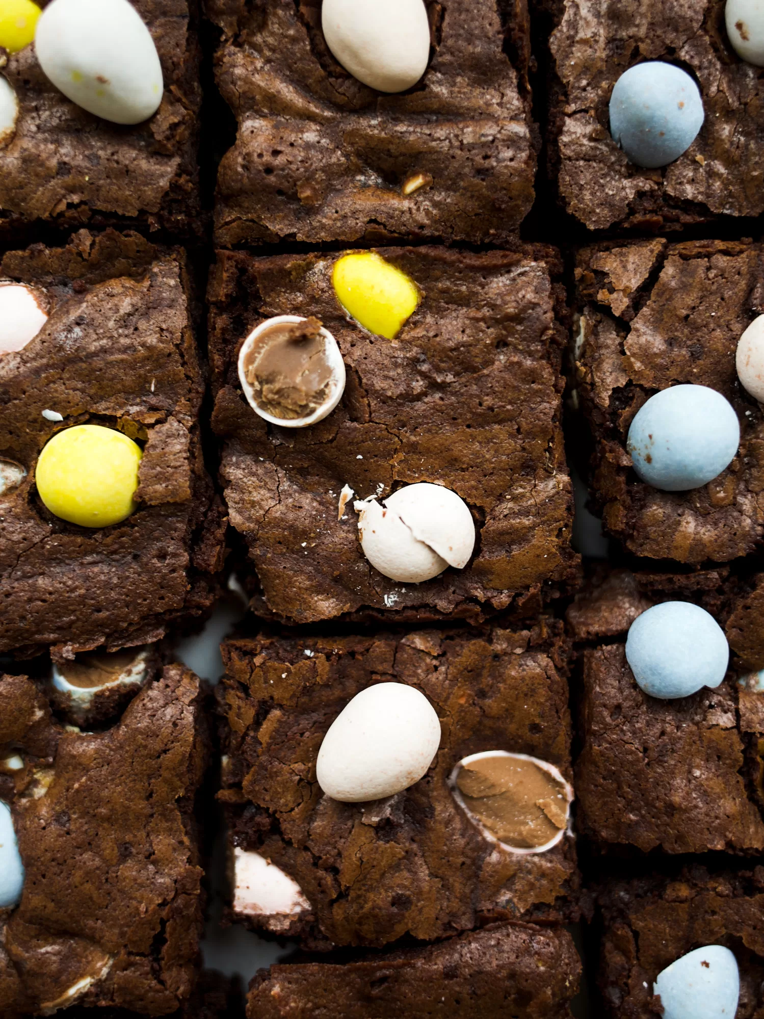 Mini Egg Brownies by Wood and Spoon blog. These are chewy homemade brownies filled with Cadbury mini eggs. These brownies are a great alternative to box mix brownies and the pastel candies make the brownies festive for the spring and Easter holidays. Find the recipe on thewoodandspoon.com