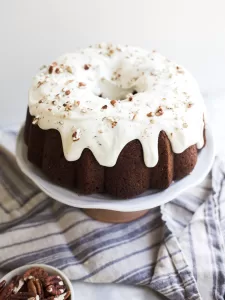 Hummingbird Bundt Cake by Wood and Spoon blog. Learn how to make this yummy textured Southern bundt cake filled with banana, coconut, pecans, and crushed pineapple! This recipe is a Southern classic and is great for th spring and easter holidays. Learn how to make it on thewoodandspoon.com