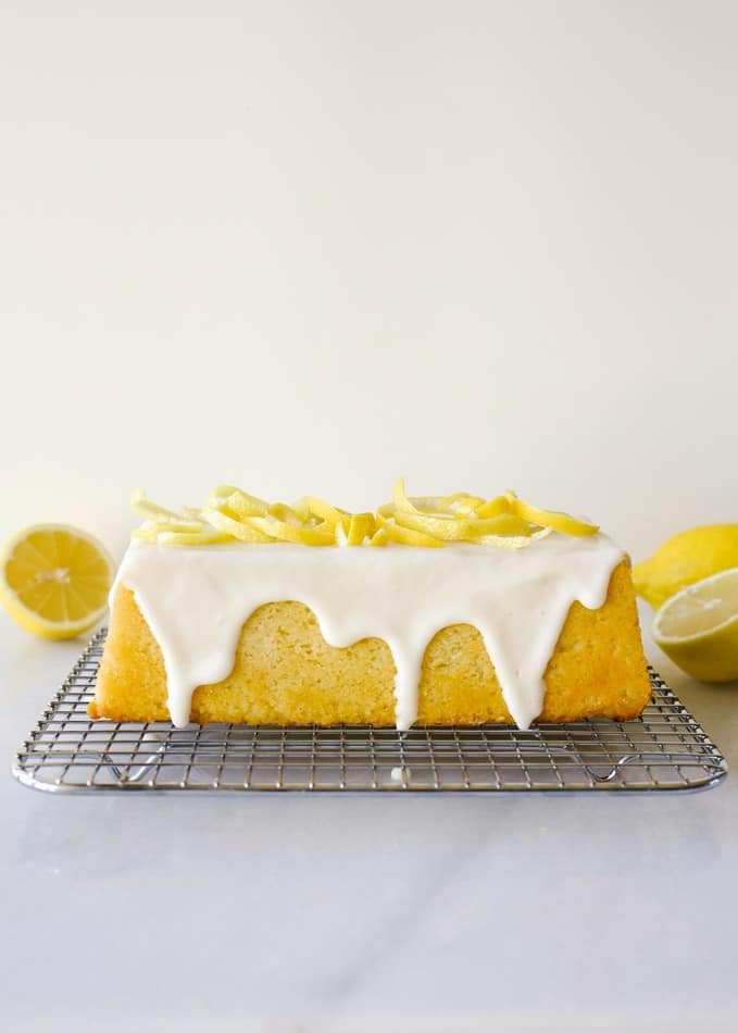 Lemon Pound Cake recipe by Wood and Spoon blog. This is a southern style pound cake loaf scented with lemon juice and zest and topped with a sweet and tangy lemon glaze. This recipe makes one loaf or three mini loaves of bread. This baked good can double as dessert or breakfast! Sweet, tart and beautifully yellow, this pound cake can be cut and served in trifles or stand alone. Find the recipe and read more at thewoodandspoon.com by Kate Wood