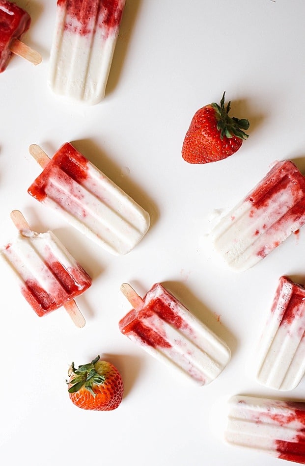 Roasted Strawberry and Buttermilk Popsicles Recipe by The Wood and Spoon Blog. A simple, summer, frozen dessert made of sweet and rich roasted strawberries and tangy buttermilk cream. These fruit popsicles are simple, make ahead, and a great dessert for outdoor parties and events. Learn about making popsicles without a popsicle mold too!