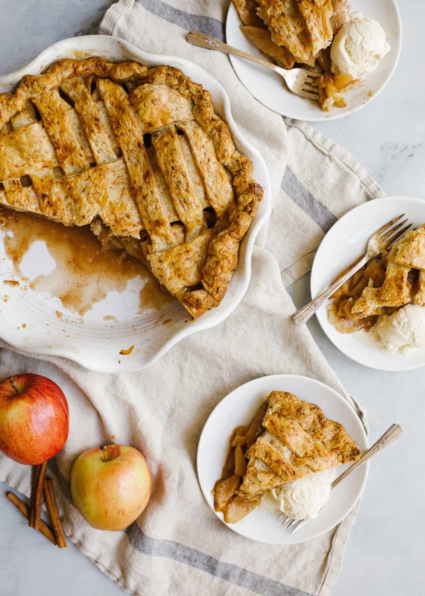 Cheddar Apple Pie by Wood and Spoon. This is an apple pie with an all-butter and cheddar cheese crust. The fruit filling is flavored with cinnamon and fall spices and is juicy. The cheddar crust is lightly flavored and flaky. Learn more about how to on this autumn lattice pie on thewoodandspoon.com