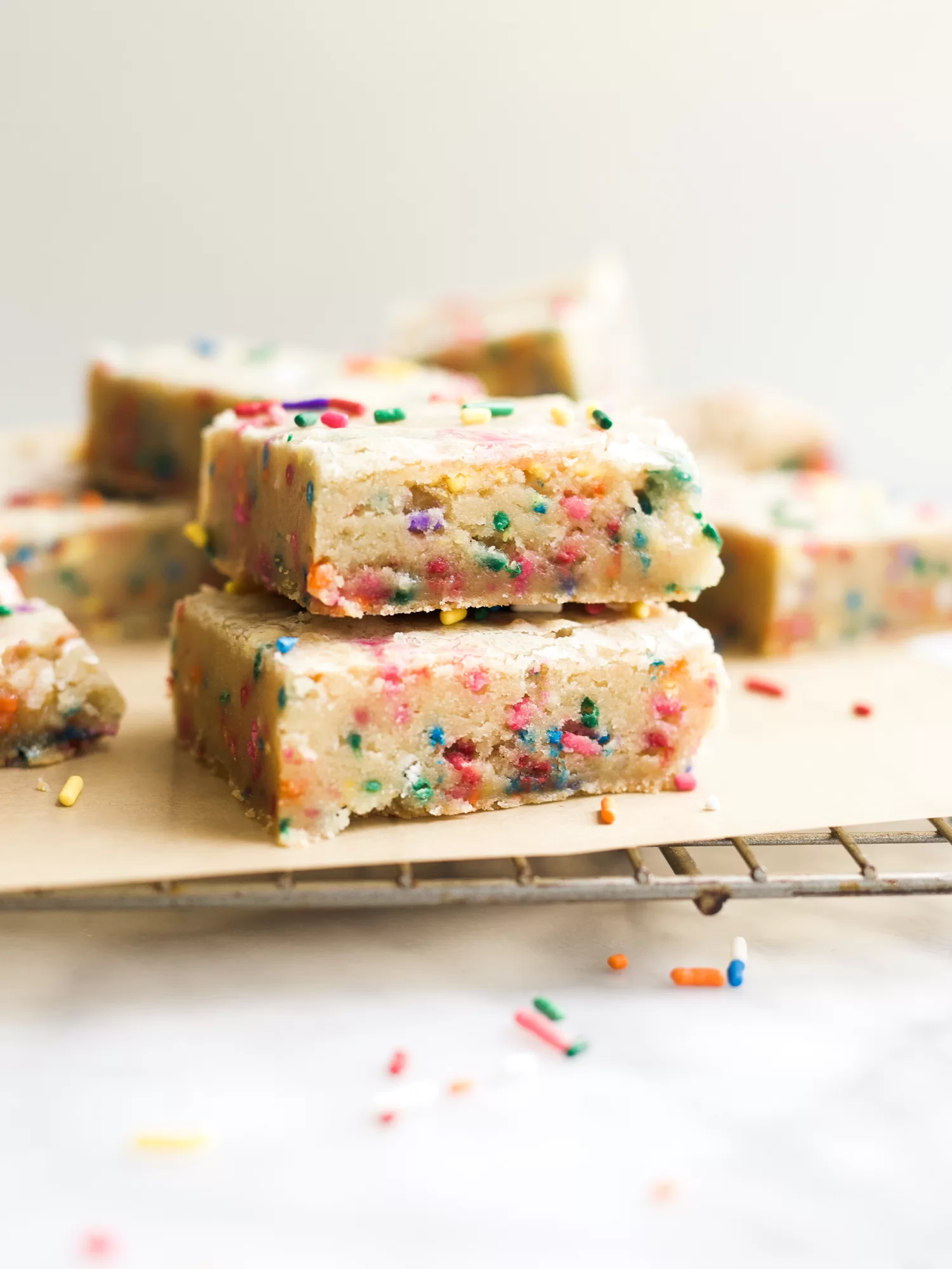 Gooey Funfetti Bars by Wood and Spoon. These are gooey blondie bars loaded with cake batter flavor and colorful sprinkles. These rich bars feed a crowd and can be made in one bowl in advance. Learn how simple these gooey sprinkle bars are on thewoodandspoon.com