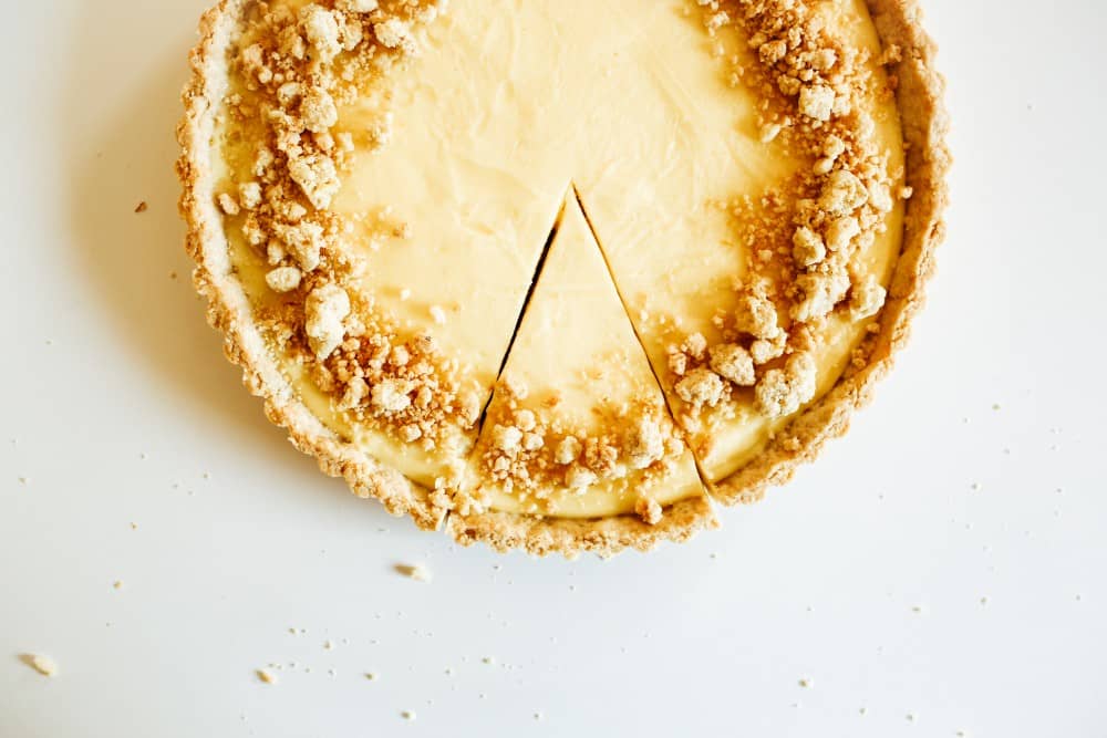 lemon almond tart recipe by the wood and spoon blog by kate wood. This is a simple almond meal flour crust, crunchy and golden, filled with a creamy custard like lemon filling. This is a take on the classic french tarte au citron. Make ahead and store in the fridge. Find the recipe for this summer fruit favorite on thewoodandspoon.com