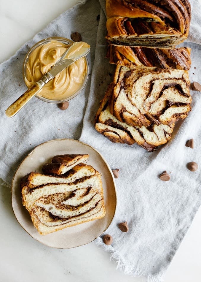 Peanut Butter Chocolate Babka by Wood and Spoon. This is a fluffy and sweetened braided bread filled with dark chocolate and peanut butter. This can serve as dessert or morning pastry! Making babka can be hard to learn how to do but with these steps you'll be baking in no time! Read more at thewoodandspoon.com by Kate Wood