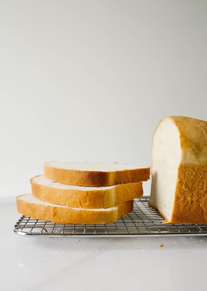 Buttermilk Bread Recipe by Wood and Spoon Blog. This is a fluffy tangy soft homemade bread recipe made without a bread maker. Buttermilk and all-purpose flour make up this mild sandwich bread that is simple for beginners and very few ingredients. You can knead by hand or using a dough hook of a stand mixer. Perfect for deli sandwiches or PB&J. Find the recipe and how to by Kate Wood on thewoodandspoon.com