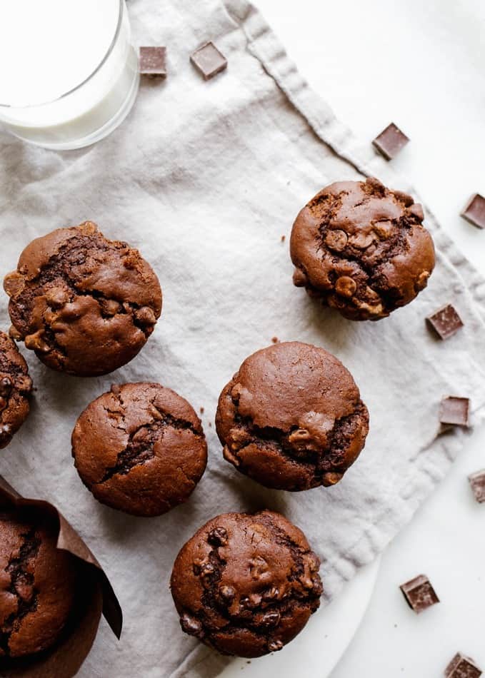 Double chocolate muffins by wood and spoon blog. These are a one-bowl recipe loaded with cocoa powder and chocolate chips. These are a simple make ahead valentines breakfast in bed option and freeze well for treats to save for later! Check out the recipe and how to for the moist cupcake like pastries on thewoodandspoon.com by Kate wood.