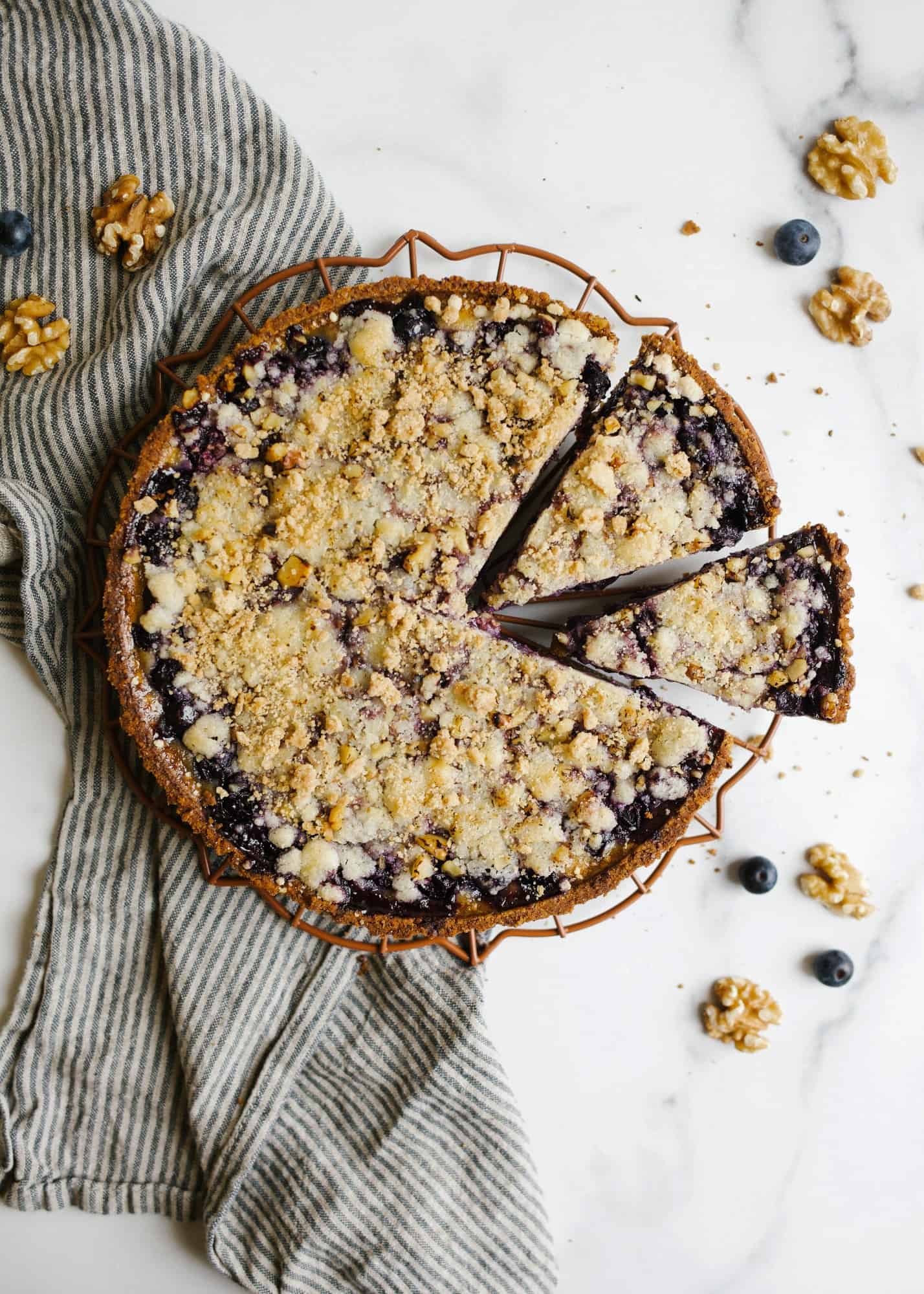 Blueberry Sour Cream Pie. This is a walnut pie crust made with a sweet sour cream filling and fresh cinnamon scented blueberries. The crumb topping adds flavor and texture as well as extra walnuts! Use a ready made crust and this simple pie has less than 10 ingredients and 10 minutes prep time. Find this simple summer recipe on thewoodandspoon.com