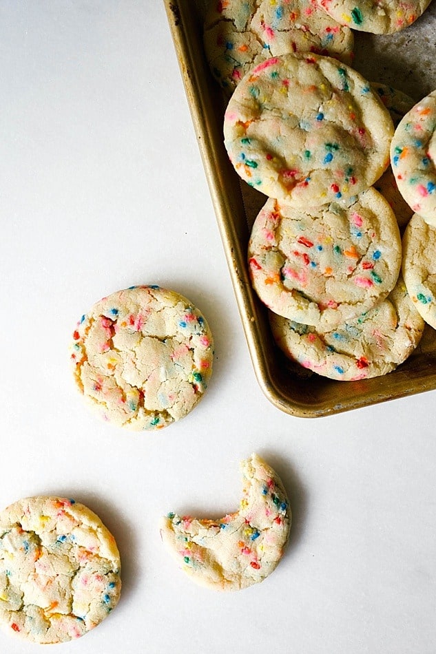 Funfetti Cookies Recipe by The Wood and Spoon Blog By Kate Wood. These are sprinkle filled sugar cookies, soft and chewy with crunchy edges. Simple, one bowl recipe that uses rainbow jimmies and clear vanilla to get that cake batter flavor in every bite. These taste like copycat cookies from great American cookie. Try these fun and kid friendly dessert recipes now on thewoodandspoon.com .