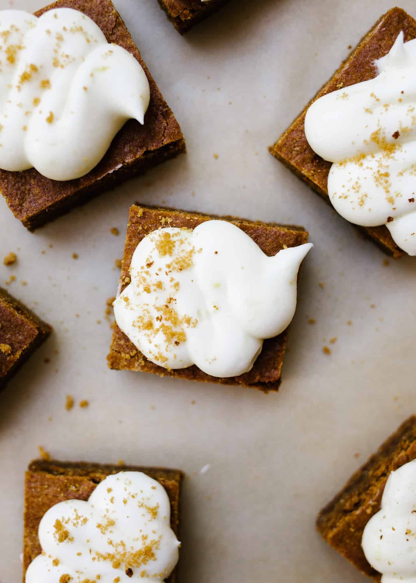 Chewy Gingerbread Lemon Bars by Wood and Spoon. These are soft blondie-like bars flavored with ginger and topped with a cream cheese and lemon frosting! These bars and sweetened and chewy, perfect for the holidays! Learn how to make these sweet gingerbread treats on thewoodandspoon.com