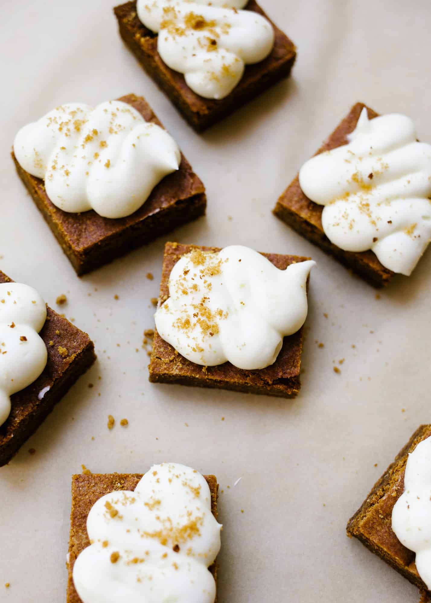 Chewy Gingerbread Lemon Bars by Wood and Spoon. These are soft blondie-like bars flavored with ginger and topped with a cream cheese and lemon frosting! These bars and sweetened and chewy, perfect for the holidays! Learn how to make these sweet gingerbread treats on thewoodandspoon.com