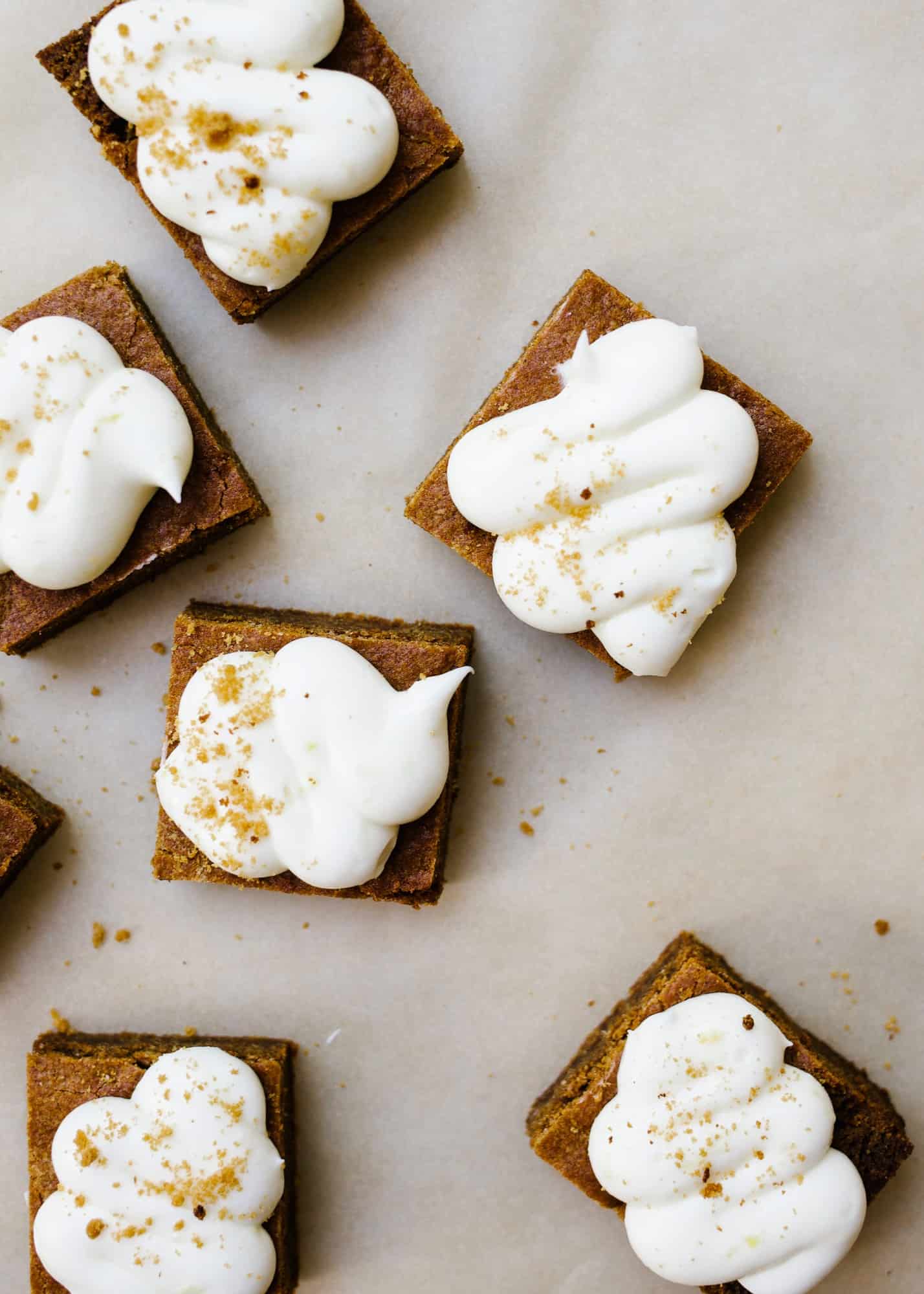 Chewy Gingerbread Lemon Bars by Wood and Spoon. These are soft blondie-like bars flavored with ginger and topped with a cream cheese and lemon frosting! These bars and sweetened and chewy, perfect for the holidays! Learn how to make these sweet gingerbread treats on thewoodandspoon.com