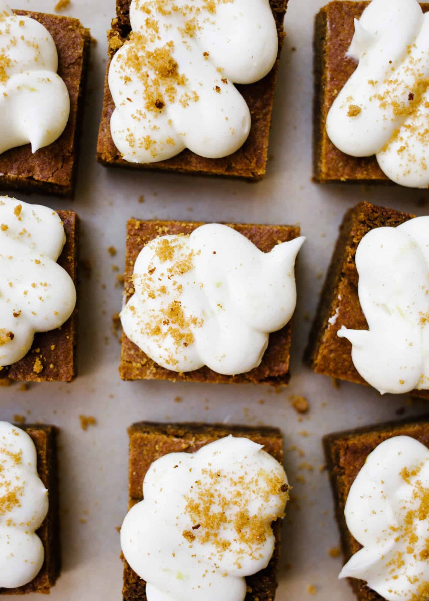 Chewy Gingerbread Bars by Wood and Spoon. These are soft blondie-like bars flavored with ginger and topped with a cream cheese and lemon frosting! These bars and sweetened and chewy, perfect for the holidays! Learn how to make these sweet gingerbread treats on thewoodandspoon.com